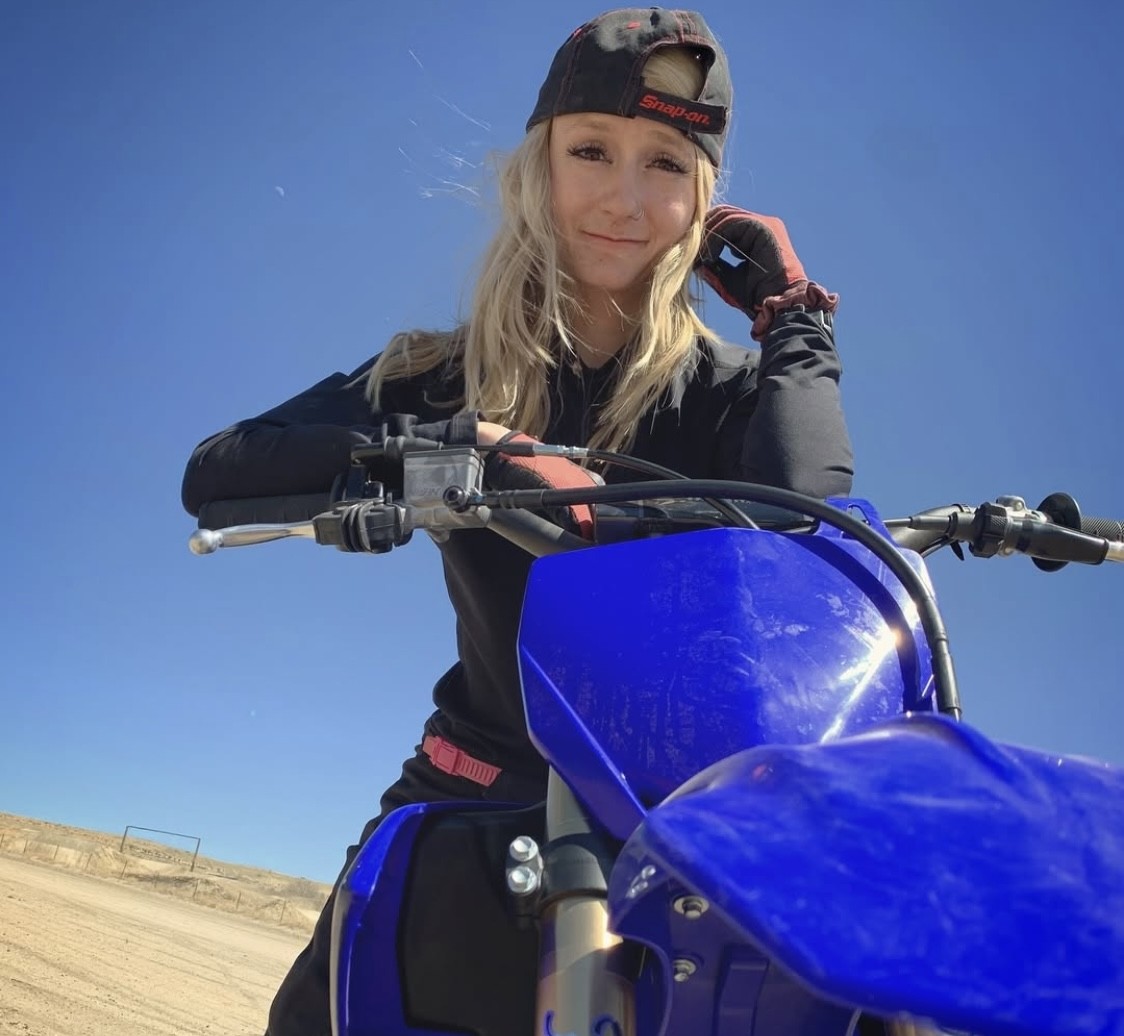blonde woman with brown eyes in red dirt bike gear